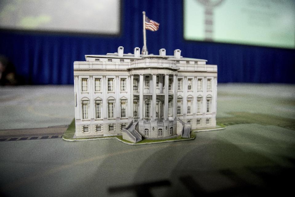 FILE - In this Dec. 14, 2016, file photo, a model of the White House is displayed on a giant planning map during a media tour highlighting inaugural preparations being made by the Joint Task Force-National Capital Region for military and civilian planners at the DC Armory in Washington. It’s typically an unquestioned honor to participate in the inauguration of an American president. This time, though, it’s different. The sharp divisions over Donald Trump’s election have politicians, celebrities and even high school students debating whether taking part in the inauguration is a political act that demonstrates support for the new president and his agenda or a nonpartisan tribute to democratic traditions and the peaceful transfer of power.(AP Photo/Andrew Harnik, File)