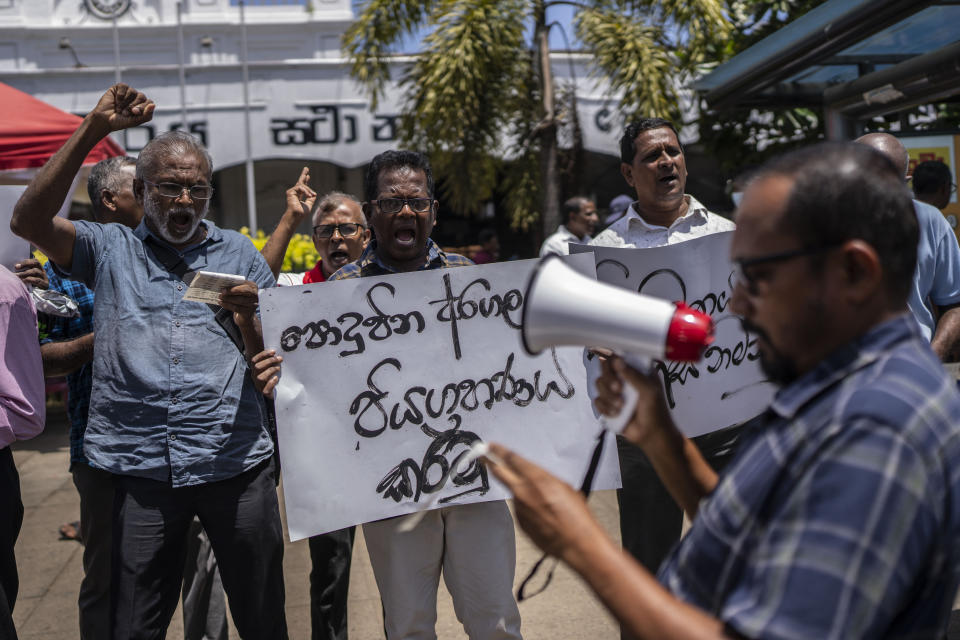 Trade union representatives and activists shout slogans during a protest against Sri Lanka’s acting president Ranil Wickremesinghe in Colombo, Sri Lanka, Monday, July 18, 2022. Wickremesinghe on Monday declared a state of emergency giving him broad authority amid growing protests demanding his resignation two days before the country's lawmakers are set to elect a new president. (AP Photo/Rafiq Maqbool)
