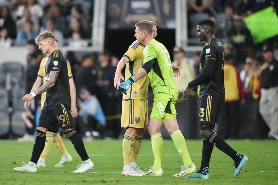 Real Salt Lake midfielder Maikel Chang, center left, and goalkeeper Zac MacMath hug as they celebrate their win over Los Angeles FC in an MLS soccer match Sunday, Oct. 1, 2023, in Los Angeles. (AP Photo/Jae C. Hong)