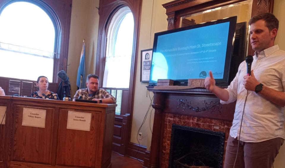 Jayson Wood of Woodland Design Associates in Honesdale discussed the status of the downtown Main Street revitalization program at the April 22, 2024, borough council meeting. At left are Councilors Tiffany Rogers and James Hamill.