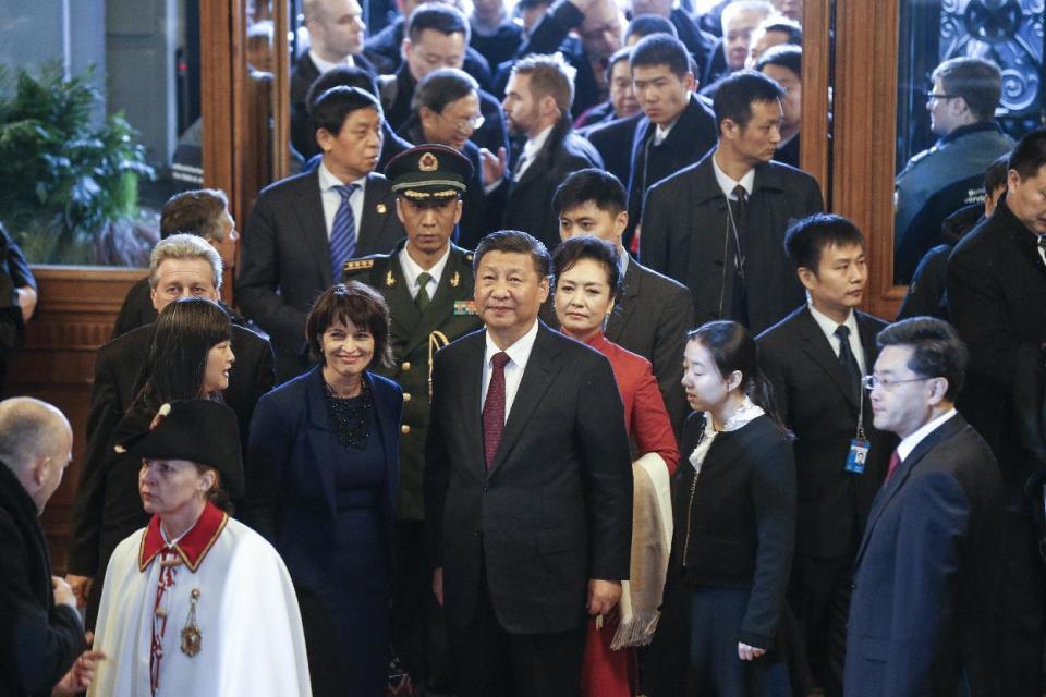 China's President Xi Jinping, center, and Swiss Federal President Doris Leuthard, center left, arrive in the house of parliament during Xi's two days state visit to Switzerland, in Bern, Switzerland, on Sunday, Jan. 15, 2017. (Peter Klaunzer/Pool Photo via AP