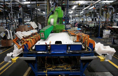 A Collaborative Robot applies hot glue adhesive to a Headliner intended for 2018 Chevrolet Bolt EV and 2018 Sonic vehicles on the assembly line at Orion Assembly in Lake Orion, Michigan, U.S., March 19, 2018. REUTERS/Rebecca Cook/Files