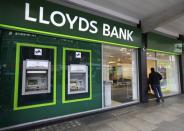 FILE PHOTO: A man enters a Lloyds Bank branch in central London, Britain February 25, 2016. REUTERS/Paul Hackett