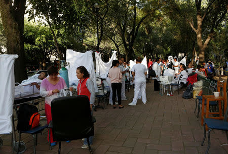 People are being treated for injuries after an earthquake hit Mexico City, Mexico September 19, 2017. Picture taken September 19, 2017. REUTERS/Ginnette Riquelme