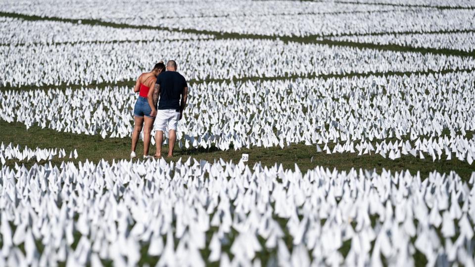 PHOTO: People visit the 'In America: Remember' public art installation near the Washington Monument on the National Mall, Sept. 18, 2021, in Washington, D.C.  (Kent Nishimura/Los Angeles Times via Getty Images)