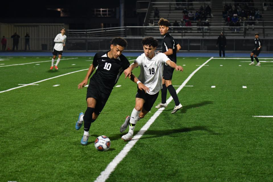 Channel Islands' Alexis Cuevas (left) is challenged by Pacifica's Ian Montelongo during the host Raiders' 3-1 Pacific View League win over the Tritons on Jan. 20.