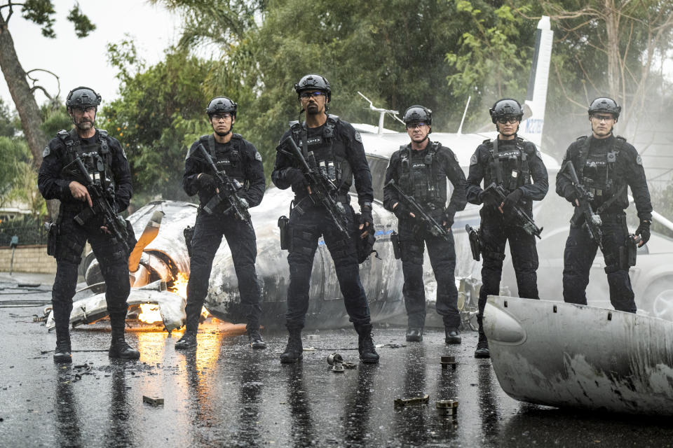 This image released by CBS shows, Jay Harrington, from left, David Lim, Shemar Moore, Kenneth "Kenny" Johnson, Lina Esco and Alex Russell in a scene from the series "S.W.A.T." The May 25 killing of George Floyd at the hands of Minneapolis police has set off protests worldwide and transmitted images of law enforcement that long remained far outside the narratives of crime stories. (Jordin Althaus/CBS via AP)