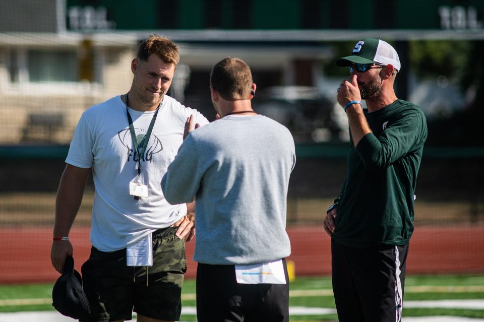 Spackenkill head football coach Josh Riley, left, talks with assistant coaches during football practice at Spackenkill High School in Poughkeepsie, NY on Saturday, August 27, 2022. KELLY MARSH/FOR THE POUGHKEEPSIE JOURNAL