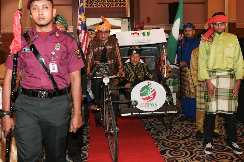 PAS Youth chief Muhammad Khalil Abdul Hadi and PAS deputy president Datuk Tuan Ibrahim Tuan Man enter the main hall at the start of Pemuda proceedings during Muktamar 2019 in Gambang, Pahang June 19, 2019. — Picture by Zamzahuri Abas