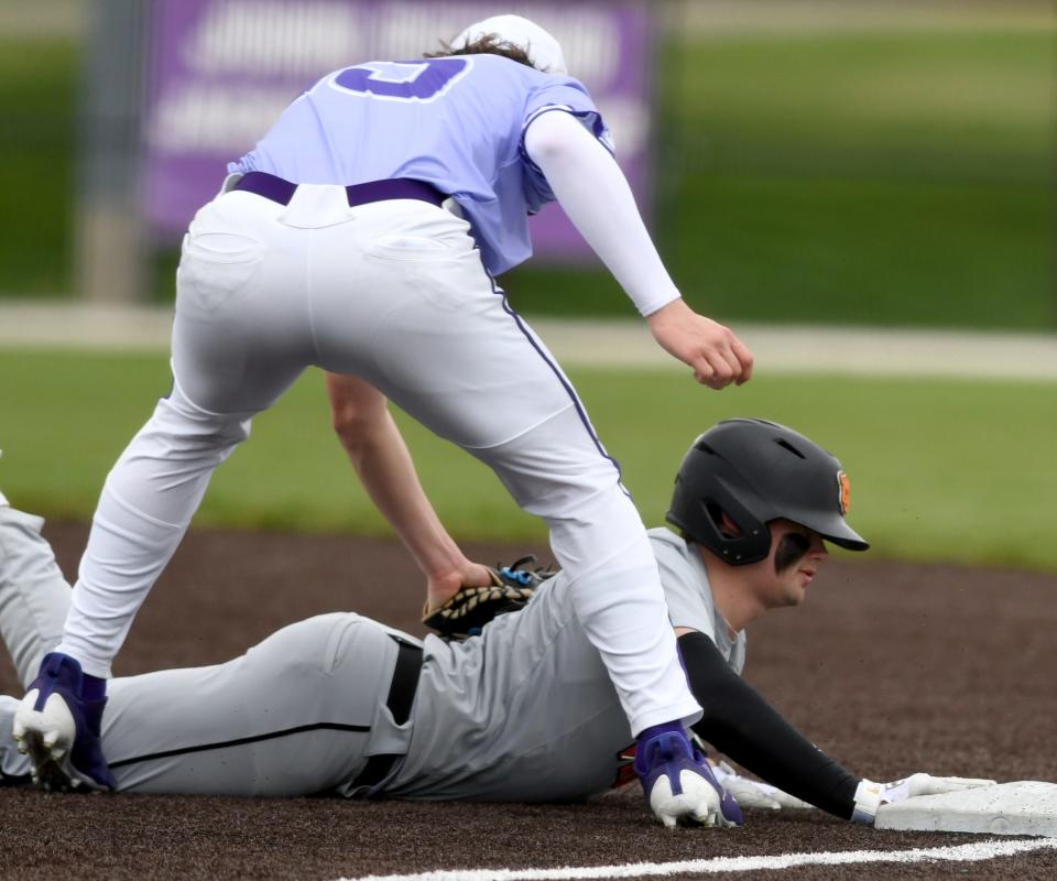 Hoover's Carter Lukens beat the tag by Jackson's Layne Keller at first in the third inning on April 9.