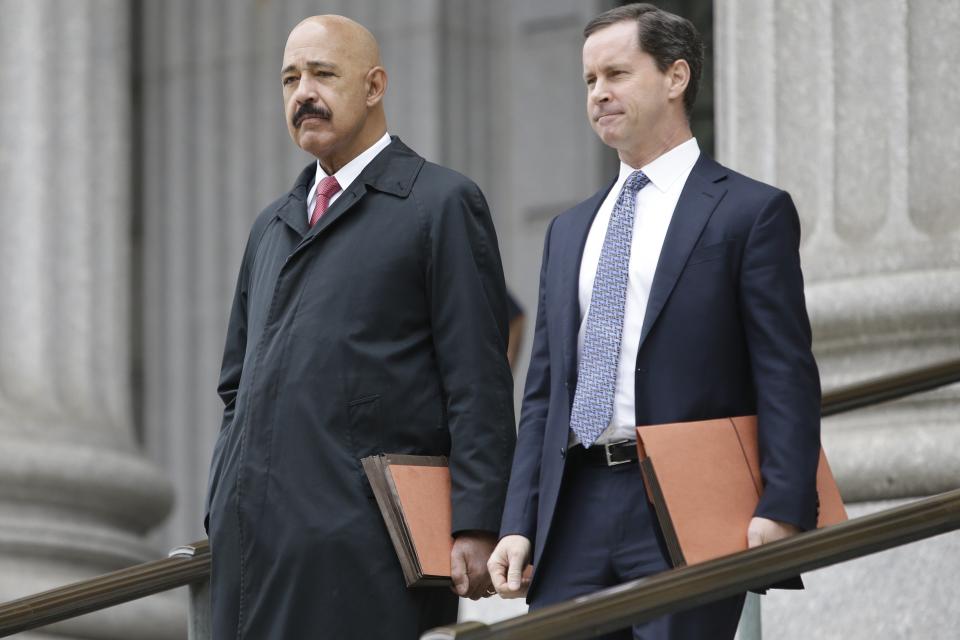 Ted Wells, Jr., left, the lead attorney for Exxon, leaves Manhattan Supreme court with a colleague Thursday, Nov. 7, 2019, in New York. New York's attorney general is accusing Exxon Mobil of misleading investors about how profitable the company will remain as governments impose stricter regulations to combat global warming. (AP Photo/Frank Franklin II)