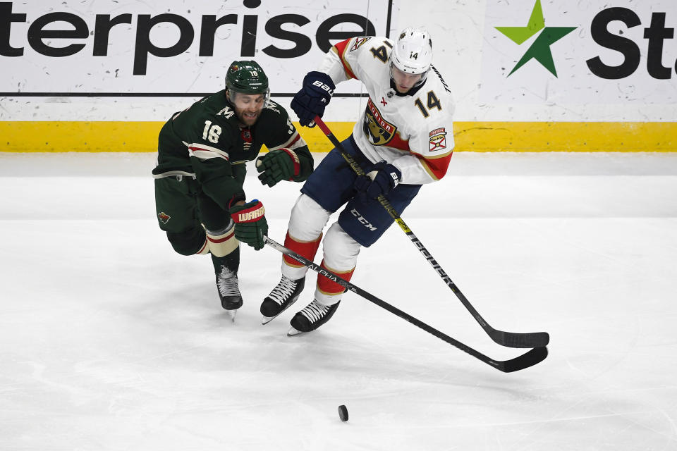 Minnesota Wild winger Jason Zucker (16) and Florida Panthers center Dominic Toninato battle for control of the puck during the first period of an NHL hockey game Monday, Jan. 20, 2020, in St. Paul, Minn. (AP Photo/Craig Lassig)