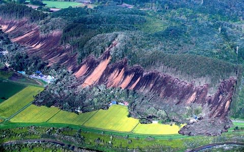 Houses were buried by multiple landslides after a powerful earthquake in Atsuma, Hokkaido - Credit: Getty