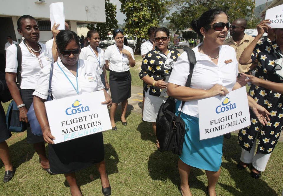 Hostesses wait for passengers of the Costa Allegra cruise ship to arrive in Victoria, Seychelles Island, Thursday, March 1, 2012. The disabled cruise ship arrived in port in the island nation of the Seychelles on Thursday morning after three days at sea without power. (AP Photo/Gregorio Borgia)