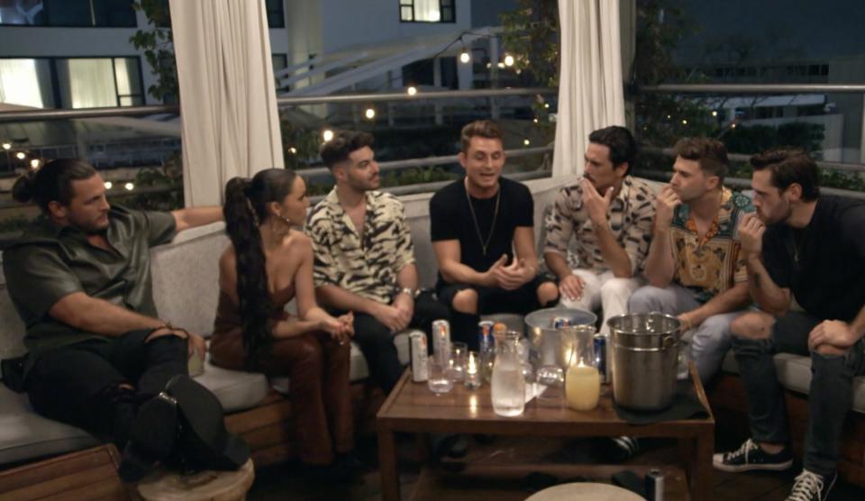 A group of Schwartz's friends gathered at a table with drinks