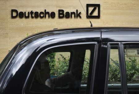 A taxi drives past the London headquarters of Deutsche Bank in the City of London, Britain May 19, 2015. REUTERS/Toby Melville