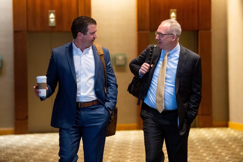 Tennessee athletics director Danny White, left, talks with SEC Commissioner Greg Sankey, right, as they walk inside the Westin Cincinnati before an NCAA infractions hearing on April 19, 2023.