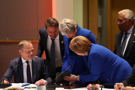 European Council President Donald Tusk, Luxembourg's Prime Minister Xavier Bettel, Britain's Prime Minister Theresa May, Germany's Chancellor Angela Merkel and Portugal's Prime Minister Antonio Costa look at a tablet ahead of a European Council meeting on Brexit at the Europa Building at the European Parliament in Brussels, Belgium April 10, 2019. Kenzo Tribouillard/Pool via REUTERS