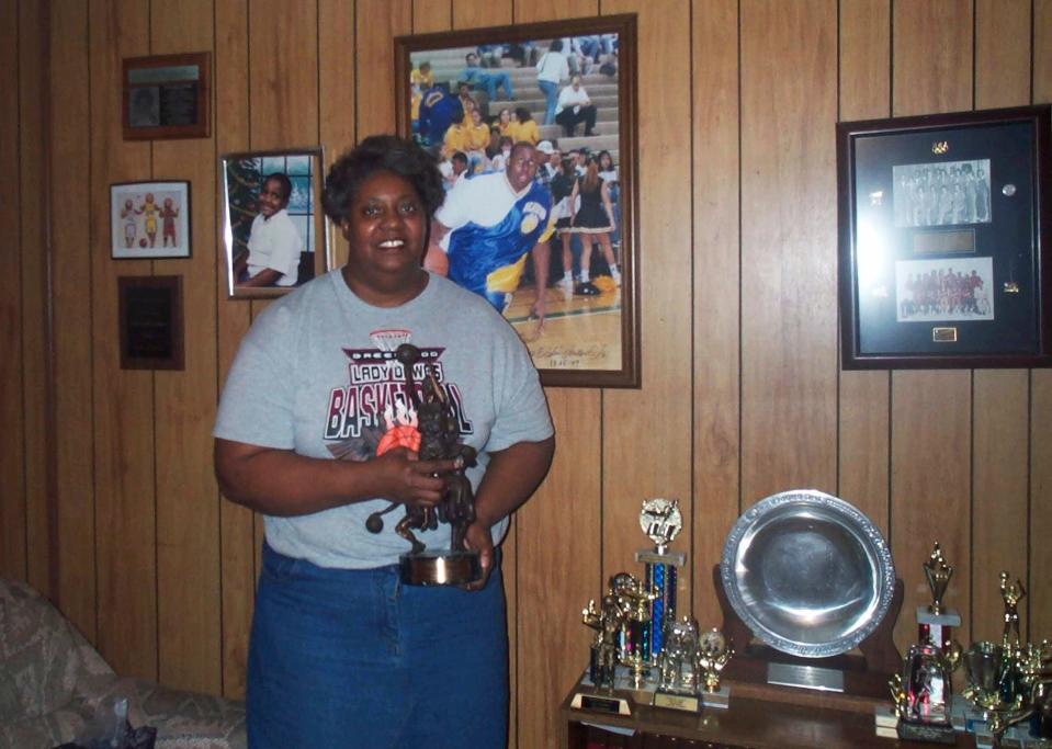 Lusia Harris Stewart shows off some of her medals and awards from her basketball career. Harris, who was the only woman to be drafted by an NBA team and scored the first points in women's basketball history at the Olympics.