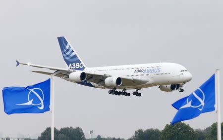 An Airbus A380, the world's largest jetliner flies over Boeing flags, as it lands after a flying display during the 51st Paris Air Show at Le Bourget airport near Paris, June 15, 2015. REUTERS/Pascal Rossignol