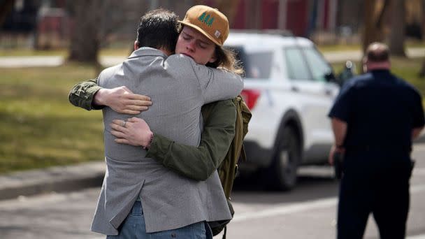 PHOTO: A student, right, hugs a man after a school shooting at East High School, March 22, 2023, in Denver. (David Zalubowski/AP)