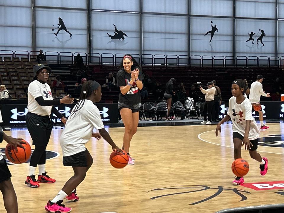Kamilla Cardoso cheers on participants during a dribbling drill at the Under Armour youth clinic hosted by South Carolina women's basketball and Notre Dame in Paris on Nov. 2, 2023.