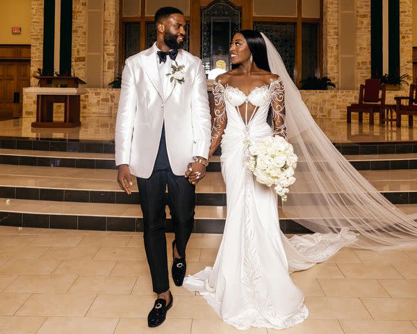 <p>Stanley Babb/StanloPhotography</p> Chiney Ogwumike walks down the aisle with Ethasor Raphael Akpejiori