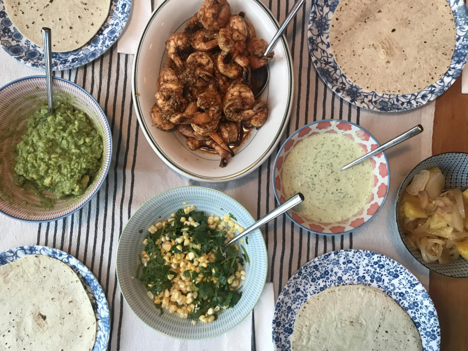 Bird's eye view of a dinner table with taco ingredients.