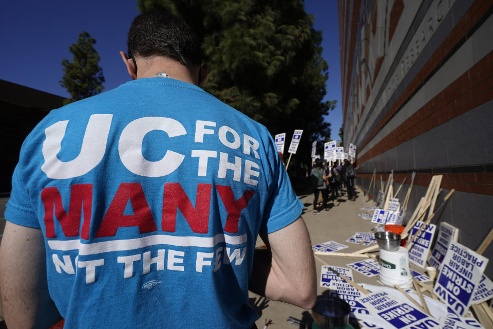 People participate in a protest outside the University of California Los Angeles, UCLA campus in Los Angeles, Monday, Nov. 14, 2022. Nearly 48,000 unionized academic workers at all 10 University of California campuses have walked off the job Monday. (AP Photo/Damian Dovarganes)