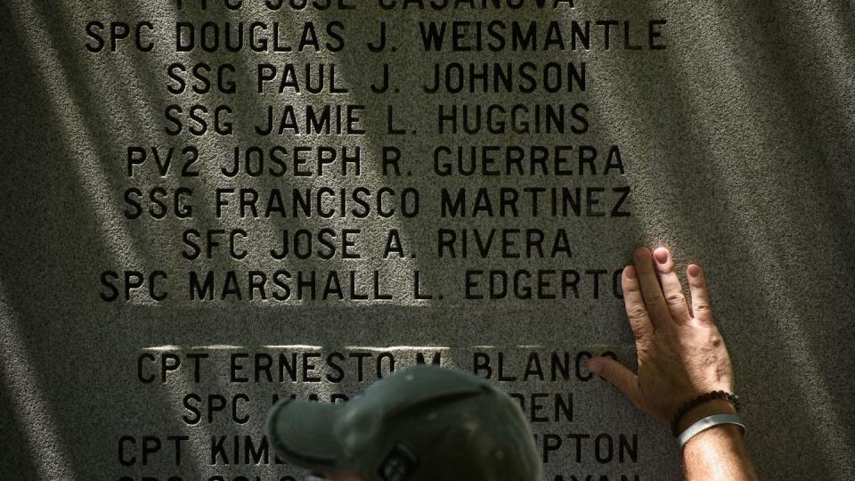 Matt Russell touches the name of Spc. Marshall Edgerton, a fallen soldier he served with, during the 82nd Airborne Division’s memorial ceremony Tuesday, May 21, 2024, at Fort Liberty. (Andrew Craft/The Fayetteville Observer)