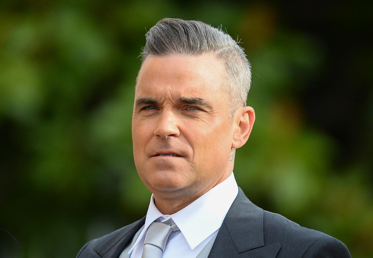 WINDSOR, ENGLAND - OCTOBER 12:  Robbie Williams attends the wedding of Princess Eugenie of York and Jack Brooksbank at St George's Chapel in Windsor Castle on October 12, 2018 in Windsor, England.  (Photo by Pool/Samir Hussein/WireImage)