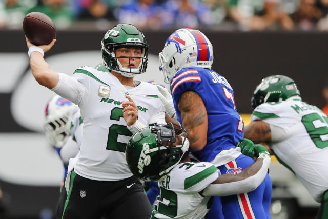 New York Jets' James Robinson (23) dives past Buffalo Bills' Tim Settle  (99) for a touchdown during the second half of an NFL football game,  Sunday, Nov. 6, 2022, in East Rutherford