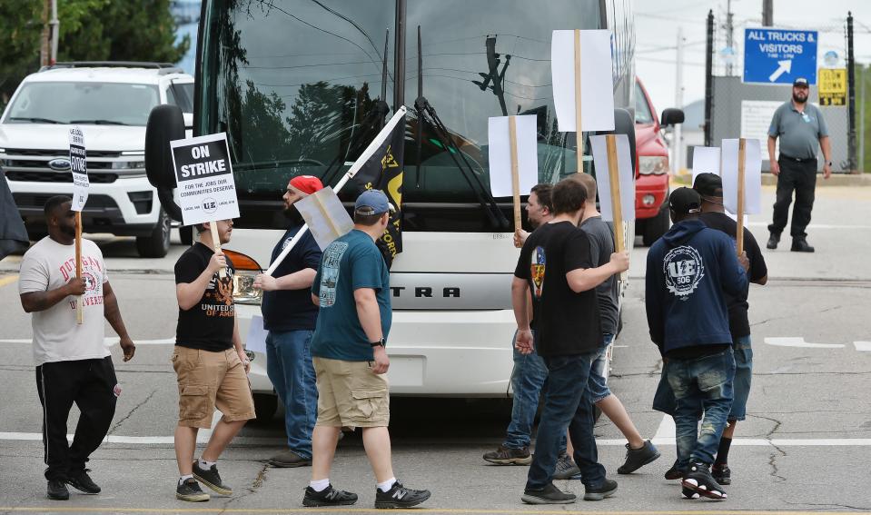 Members of the United Electrical, Radio and Machine Workers of America walk a picket line at the Wabtec Corp. Franklin Avenue gate, blocking a charter bus from exiting, in Lawrence Park Township on June 23.