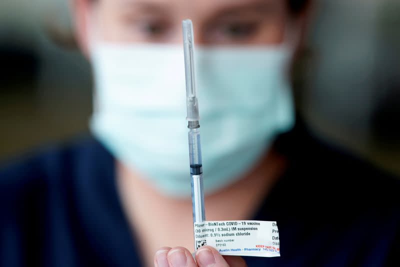 FILE PHOTO: FILE PHOTO: The Pfizer COVID-19 vaccine is prepared by a healthcare worker in Melbourne