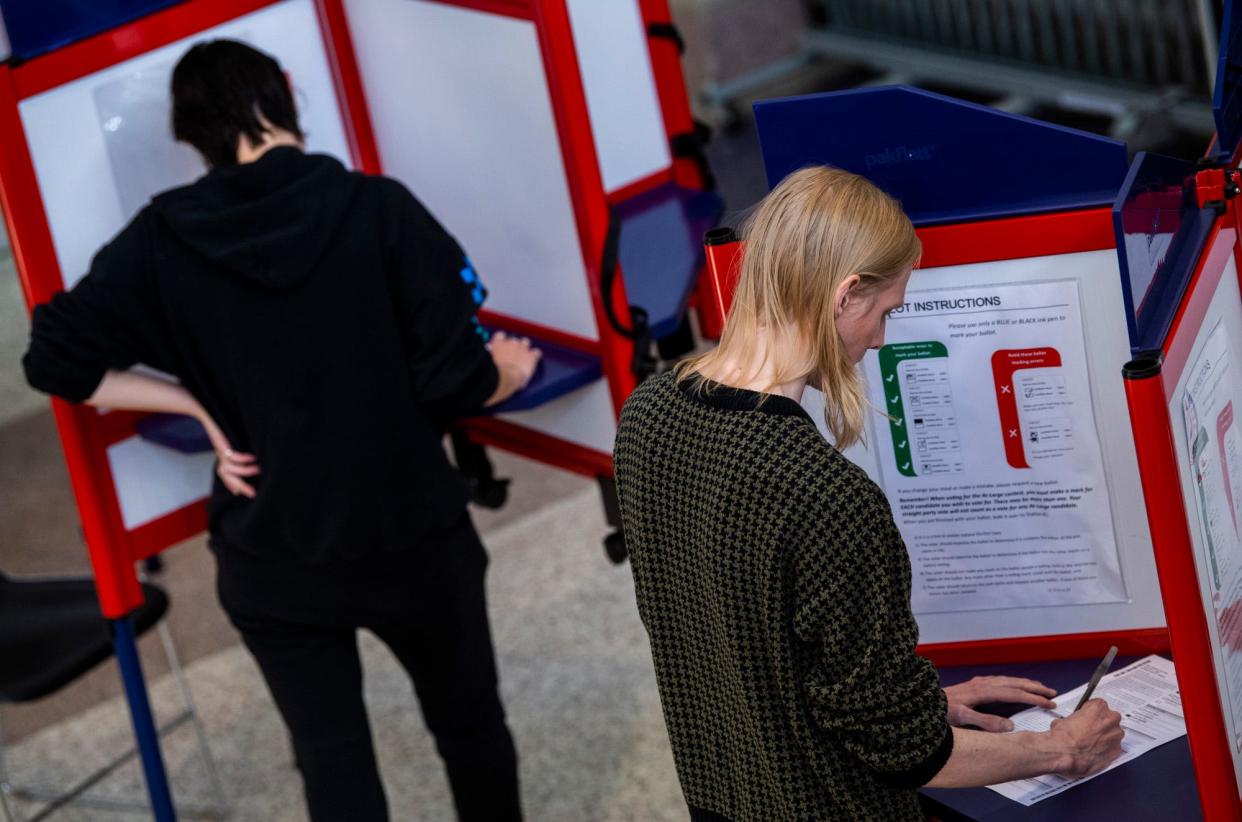 Voters make their selections while voting at Bloomington High School South on Tuesday, Nov.. 8, 2022.