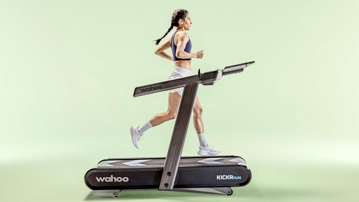  Woman running on Wahoo KICKR RUN Treadmill. 