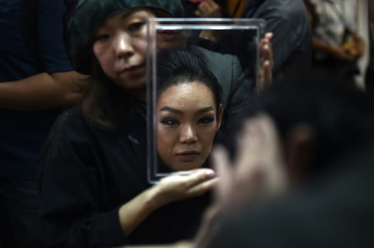 Yuko of Japan gets ready in the dressing room before the final round of the Miss International Queen 2018 transgender beauty pageant in Pattaya