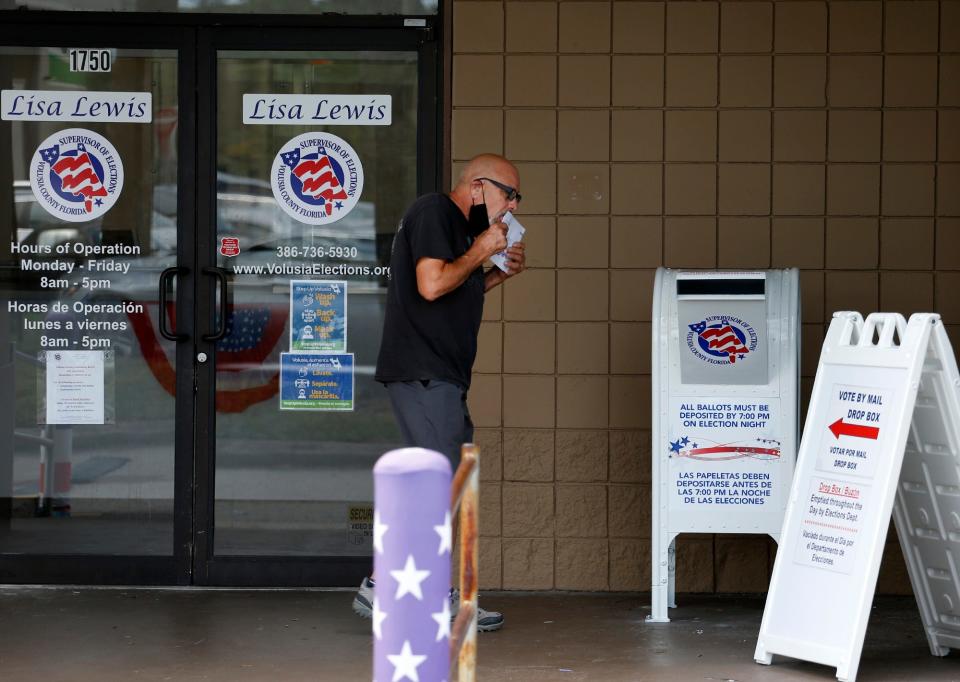 A voter prepares to drop off his ballot at the Supervisor of Elections office in DeLand on the last day of early voting, Nov. 1, 2020.