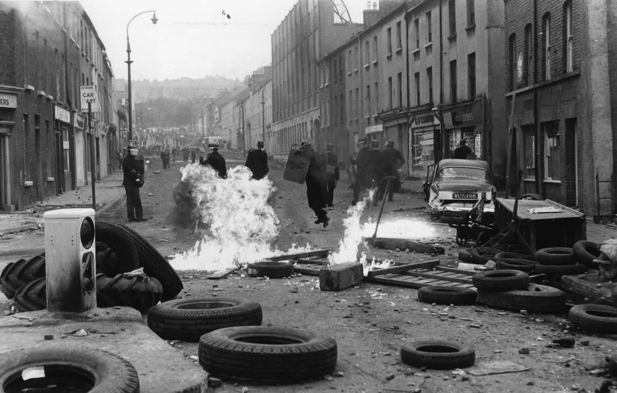 August 1969: Riot police running from exploding petrol bombs (Getty Images)
