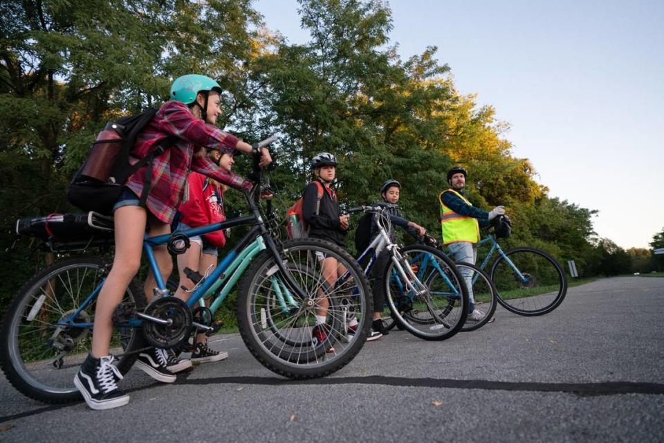 From left: Nathalie, Annabelle, Adam and Liam line up while Jeff (last name) leads the front during a morning bike train in Edwardsville, Ill. on Oct. 6, 2023.