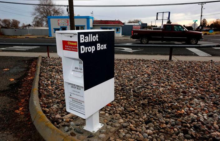 A pickup drives past a new Benton County ballot drop box recently installed in the parking lot of the Finley Middle School at 37208 S. Finley Road.