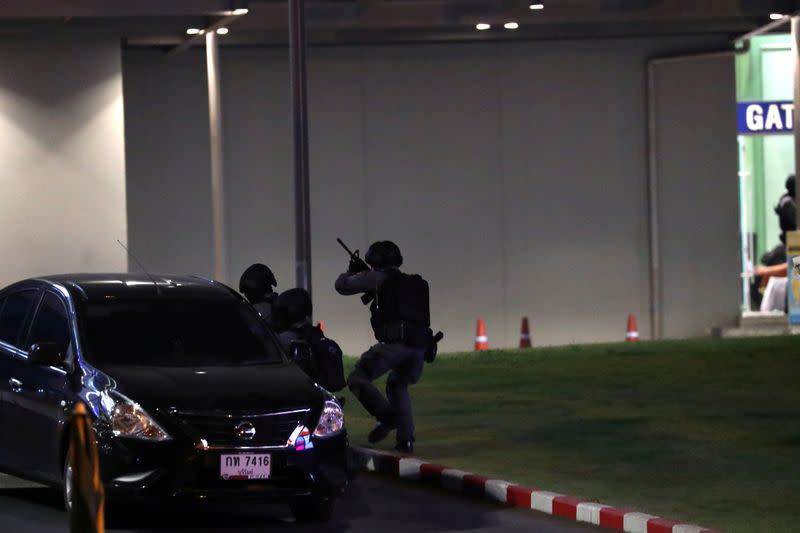 Thailand security forces enter in a shopping mall as they chase a shooter hidden inside after a mass shooting in front of the Terminal 21, in Nakhon Ratchasima, Thailand