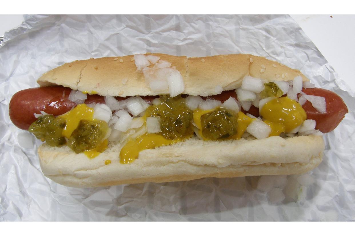 Costco hot dog with mustard, onions, and relish.