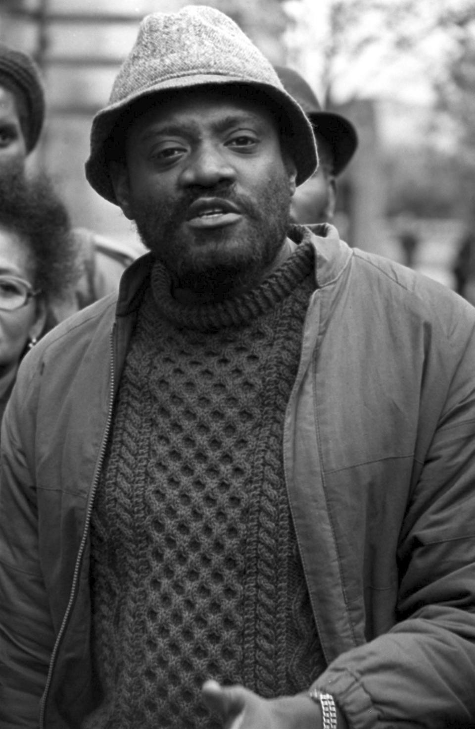 FILE - In this April 24, 1981 file photo, author and broadcaster Darcus Howe walks. The biographer of British black activist Darcus Howe says he has died. The 74-year-old died in his sleep on Saturday, April 1, 2017. (PA via AP, File)