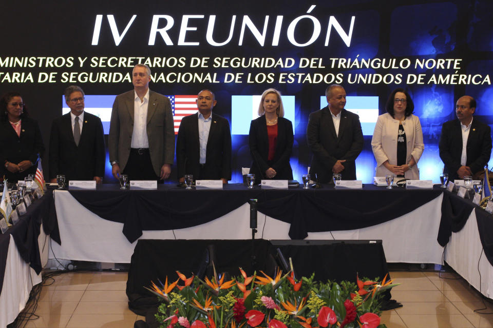 U.S. Secretary of Homeland Security Kirstjen Nielsen, center right, stands with Guatemala's Interior Minister Enrique Degenhart, third from left, El Salvador Minister of Justice and Public Security Mauricio Ramirez Landaverde, center left, and Honduran Security Minister Julian Pacheco, third right, at the start of a meeting on migration and security issues between Nielsen and government ministers from the Northern Triangle countries of Central America, in San Salvador, El Salvador, Wednesday, Feb. 20, 2019. (AP Photo/Salvador Melendez)