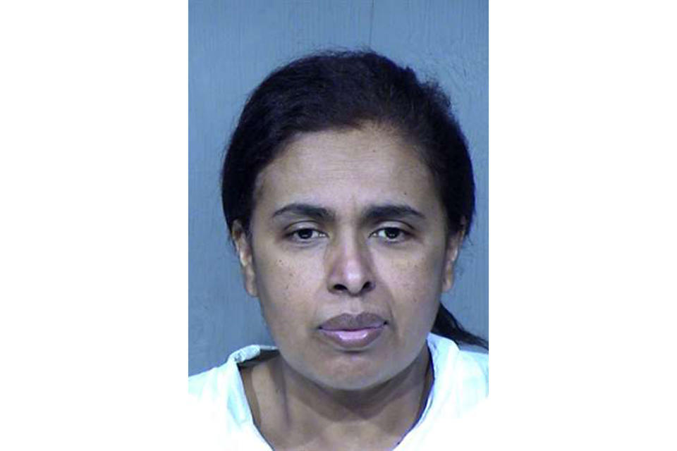 This undated booking photo provided by the Maricopa County Sheriff's Office shows 50-year-old Maribel Loera. Loera and her husband, 56-year-old Rafael Loera, are accused of intentionally setting their west Phoenix home ablaze after their children were taken by the state, leading firefighters to find unidentified skeletal remains. They have been booked on suspicion of arson, child abuse and concealment of a dead body. Authorities haven't determined whether the remains belong to a child or adult. (Maricopa County Sheriff's Office via AP)