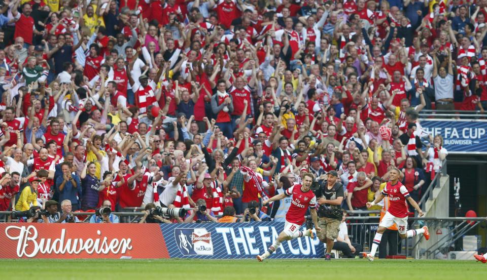 Arsenal's Aaron Ramsey (L) celebrates with team mate Kieran Gibbs after scoring his team's third goal during their FA Cup final soccer match against Hull City at Wembley Stadium in London, May 17, 2014. REUTERS/Eddie Keogh (BRITAIN - Tags: SPORT SOCCER)