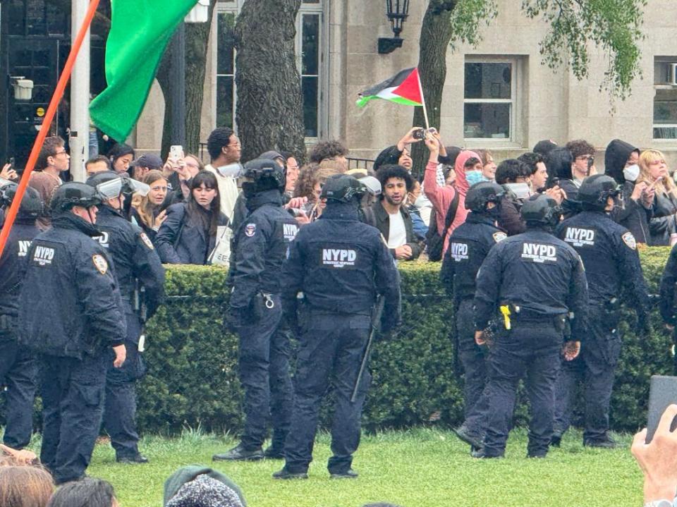 NYPD cops and protesters face off. Robert Miller