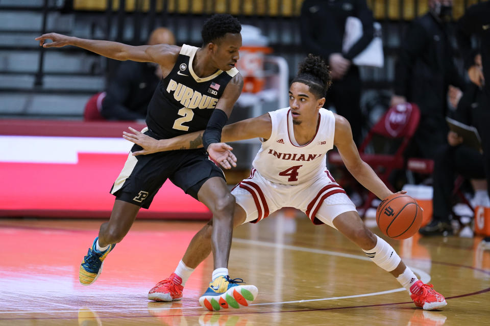 Indiana's Khristian Lander (4) is defended by Purdue's Eric Hunter Jr. (2) during the first half of an NCAA college basketball game Thursday, Jan. 14, 2021, in Bloomington Ind. (AP Photo/Darron Cummings)