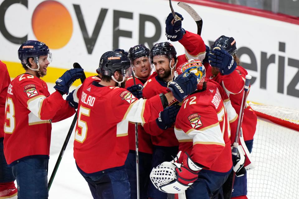 Teammates mob Florida goaltender Sergei Bobrovsky (72) after the Panthers beat the Boston Bruins, 7-5, in Game 6 of their first-round playoff series on Friday.